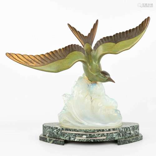 An Art Deco statue of a seagull on an illuminated glass base...