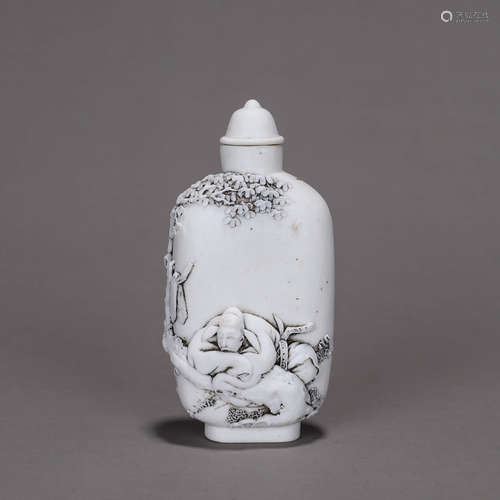 A figure carved porcelain snuff bottle