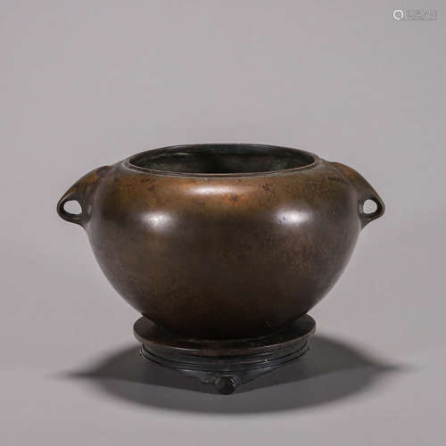 A round copper censer with a pedestal and elephant head-shap...