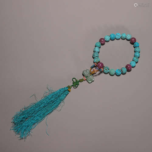 A string of 18 inscribed turquoise beads