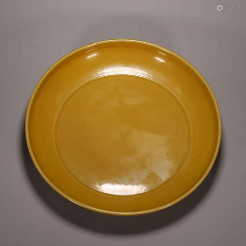 A yellow glazed porcelain plate