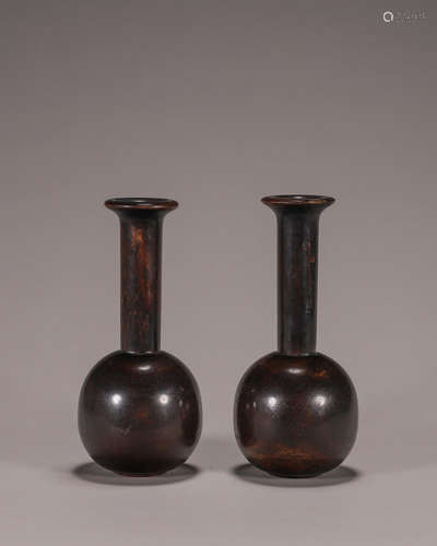 A pair of red sandalwood vases