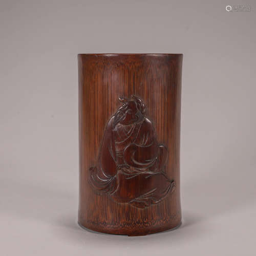 A carved bamboo brush pot