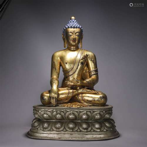 A buddha statue with silver lotus pedestal