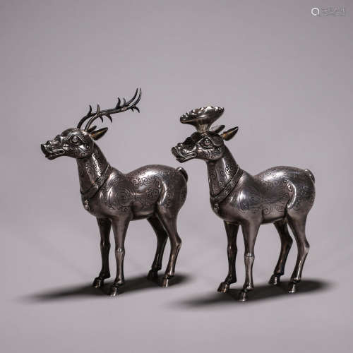 A pair of silver deer ornaments