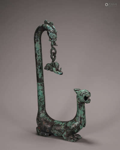 A bronze dragon and tiger shaped lamp