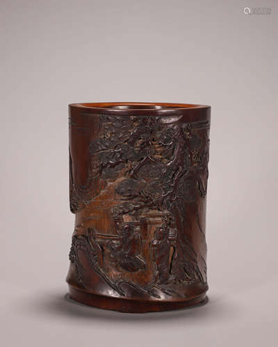 A carved bamboo brush pot