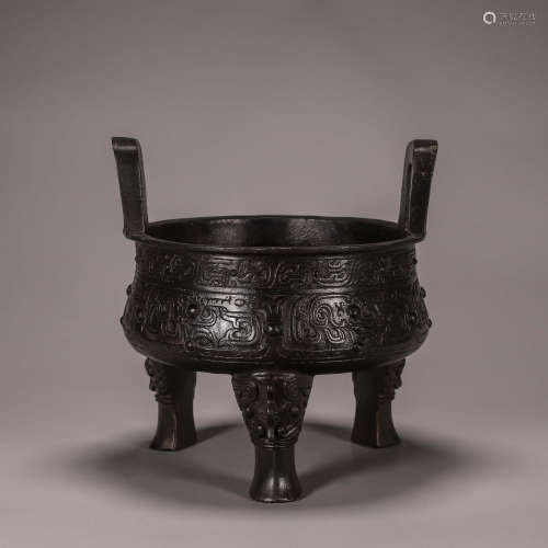 A taotie patterned bronze three-legged pot