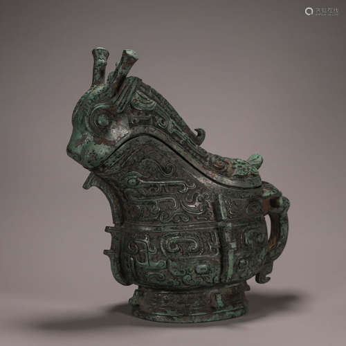 A taotie patterned bronze goat head pot