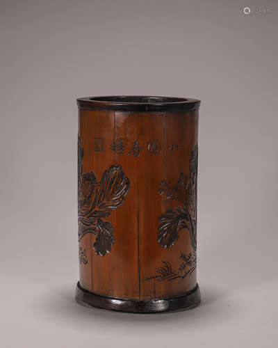 A carved bamboo brush pot