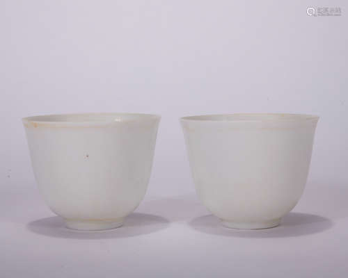 A pair of white glazed cup