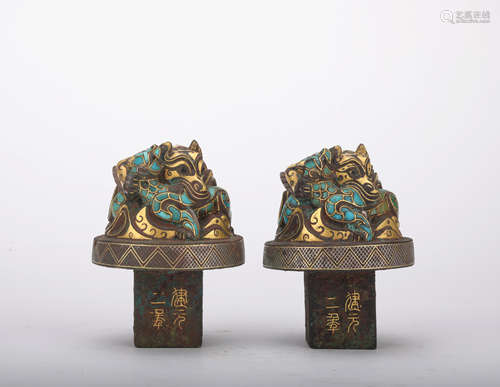 A pair of bronze beast ware with gold and silver