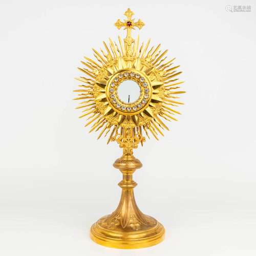 A traditional solar monstrance made of brass with cut glass ...