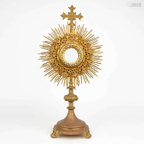 A traditional solar monstrance made of brass with cut glass ...