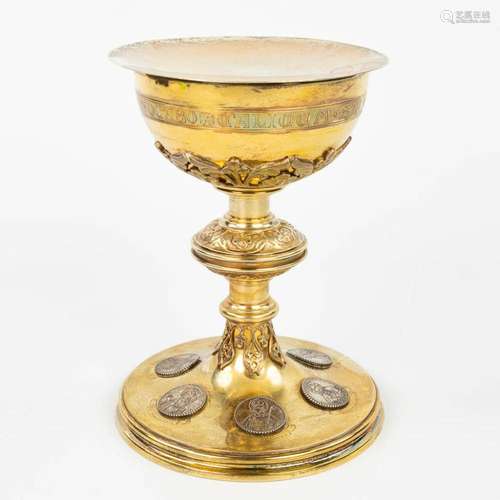 A neoroman chalice made of silver with images of holy figuri...