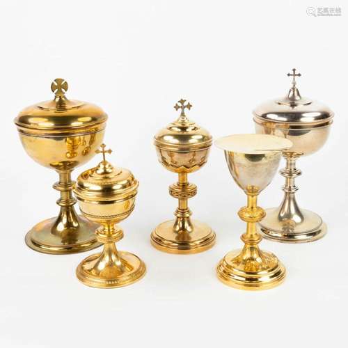 A collection of 4 large ciboria and a chalice made of silver...