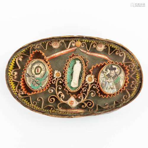 An antique relic in an oval box, marked Agnus Dei, H Relique...