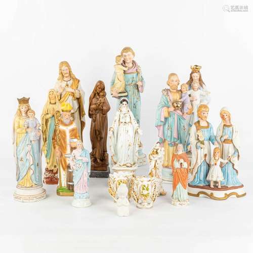 A large collection of 16 coloured bisque statues of holy fig...