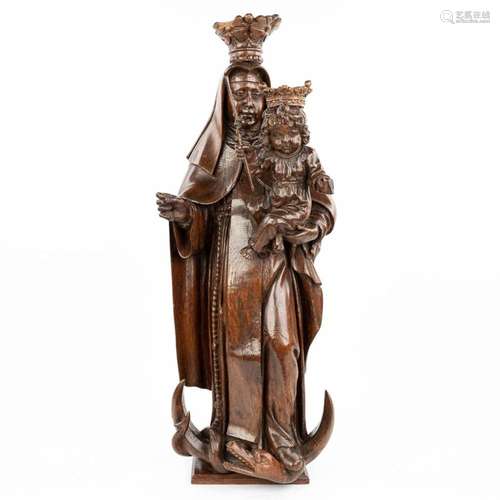 A large statue of Madonna with a child, trampling the serpen...