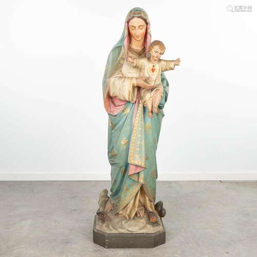 A statue of Madonna with child, trampling the serpent, made ...