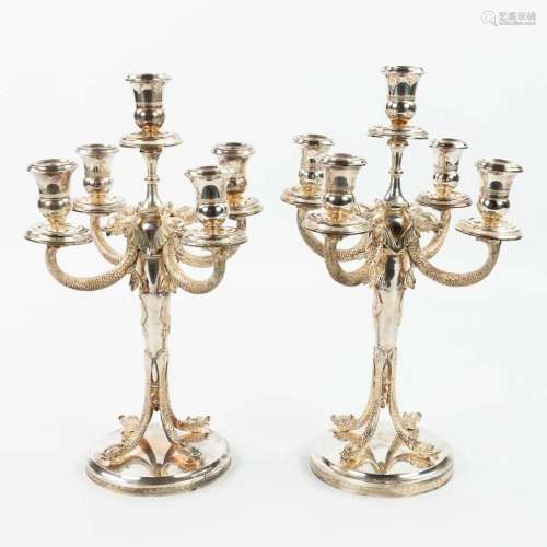 A pair of silver candelabra, decorated with mythological fig...