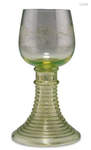 A BOHEMIAN LIGHT GREEN GLASS ROEMER, CIRCA 1890, the bowl en...