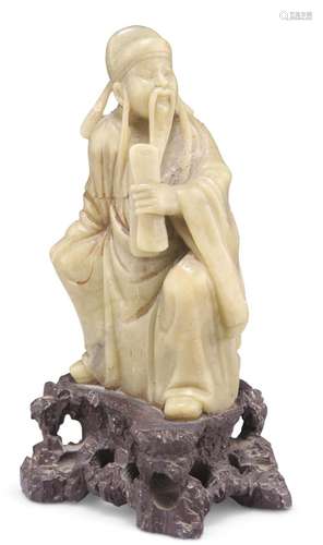 A CHINESE CARVED SOAPSTONE FIGURE OF IMMORTAL CAO GUOJIU, de...