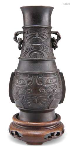 A CHINESE BRONZE VASE, HU, of pear shape, cast with archaist...