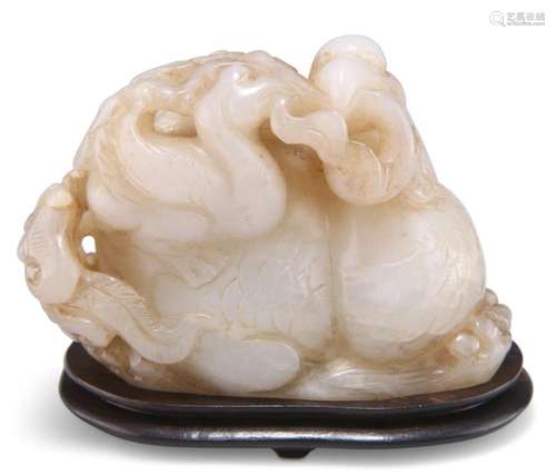 A CHINESE JADE CARVING, depicting a phoenix and young holdin...