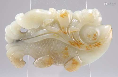 A CHINESE JADE CARVING, of a fish clasping a lotus in its mo...