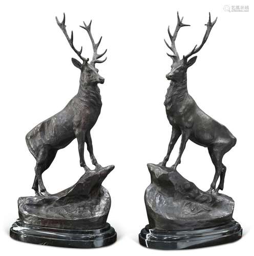 A PAIR OF LARGE BRONZE STAGS, each modelled standing on a ro...