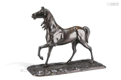 A PATINATED BRONZE MODEL OF A HORSE, cast with a foreleg rai...