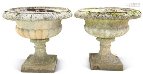 A LARGE PAIR OF WEATHERED COMPOSITE STONE URN-FORM PLANTERS....