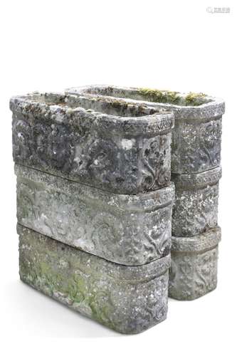 A GROUP OF SIX COMPOSITE STONE PLANTERS, rectangular with ro...