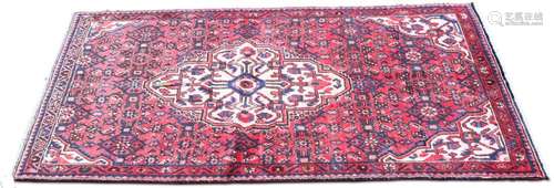 A PERSIAN HOSSEINABAD RUG, hand-knotted, the raspberry field...