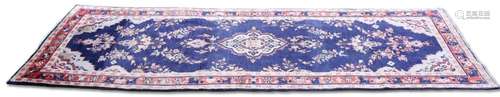 A PERSIAN SAROUK RUNNER, hand-knotted, the dark blue field w...