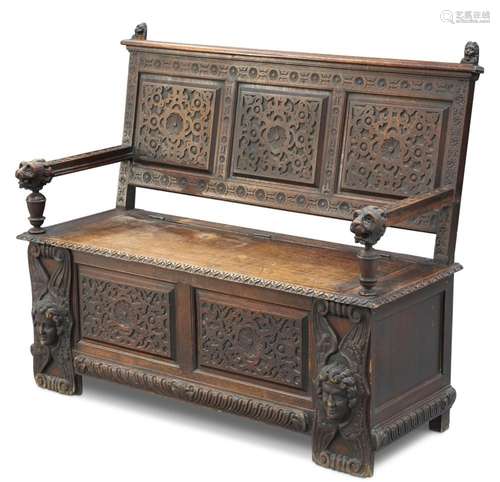 A VICTORIAN CARVED OAK SETTLE, with three-panel back and box...