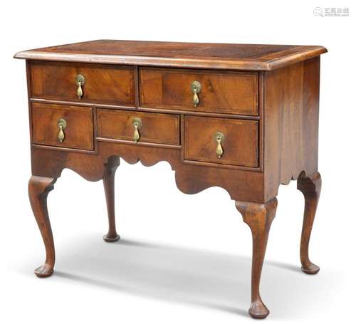 AN EARLY 18TH CENTURY WALNUT LOWBOY, the crossbanded and mou...