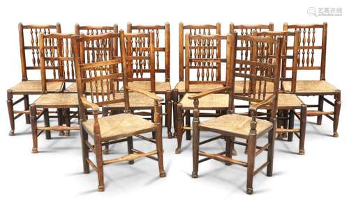 A SET OF TWELVE RUSH-SEATED OAK DINING CHAIRS, CIRCA 1800-10...