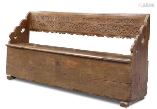 AN 18TH CENTURY OAK SETTLE, the box seat with hinged lid, th...