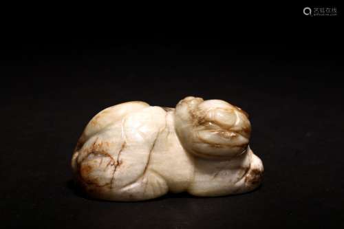 A CHINESE WHITE AND RUSSET JADE RECUMBENT LION