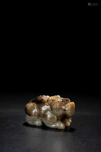 A CHINESE CELADON AND BLACK JADE MYTHICAL BEAST