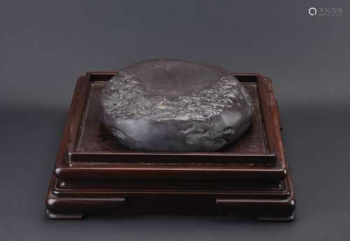 A VERY LARGE DUAN INKSTONE WITH HARDWOOD STAND
