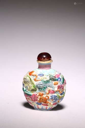 A CHINESE MOULDED FAMILLE ROSE 'BUDDHIST LIONS' SNUFF BOTTLE