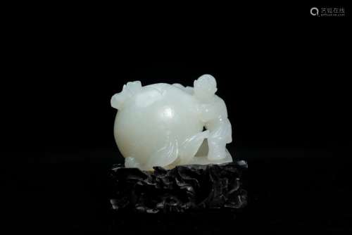 A CHINESE WHITE JADE 'BOY AND PEACH' CARVING