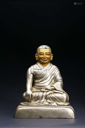 A SILVER FIGURE OF LAMA WITH COLD-GILT FACE