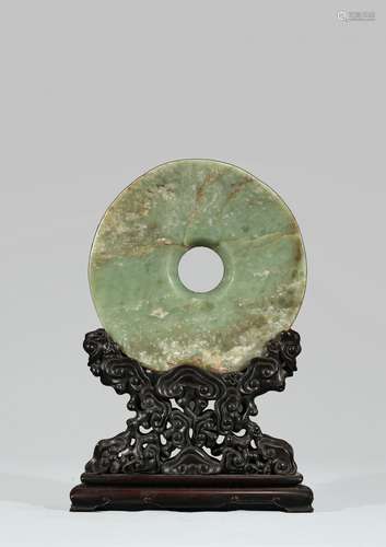 LARGE ARCHAIC CELADON JADE DISC WITH HARDWOOD STAND