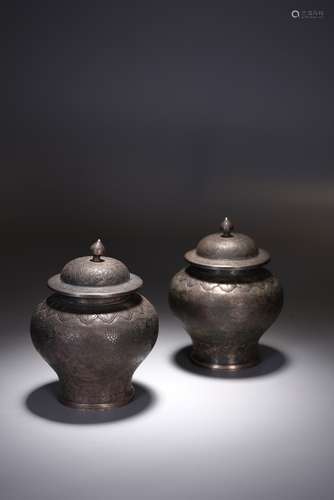 A PAIR OF CHINESE SILVER 'FLOWERS' ENGRAVED JARS AND COVERS