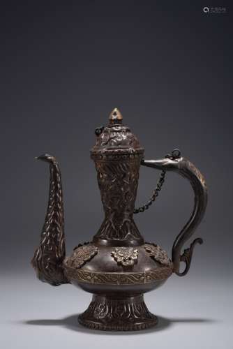 A PARCEL GILT REPOUSSE BRONZE EWER WITH COVER