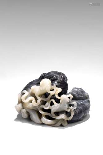 A BLACK AND WHITE JADE 'MYTHICAL BEASTS' GROUP